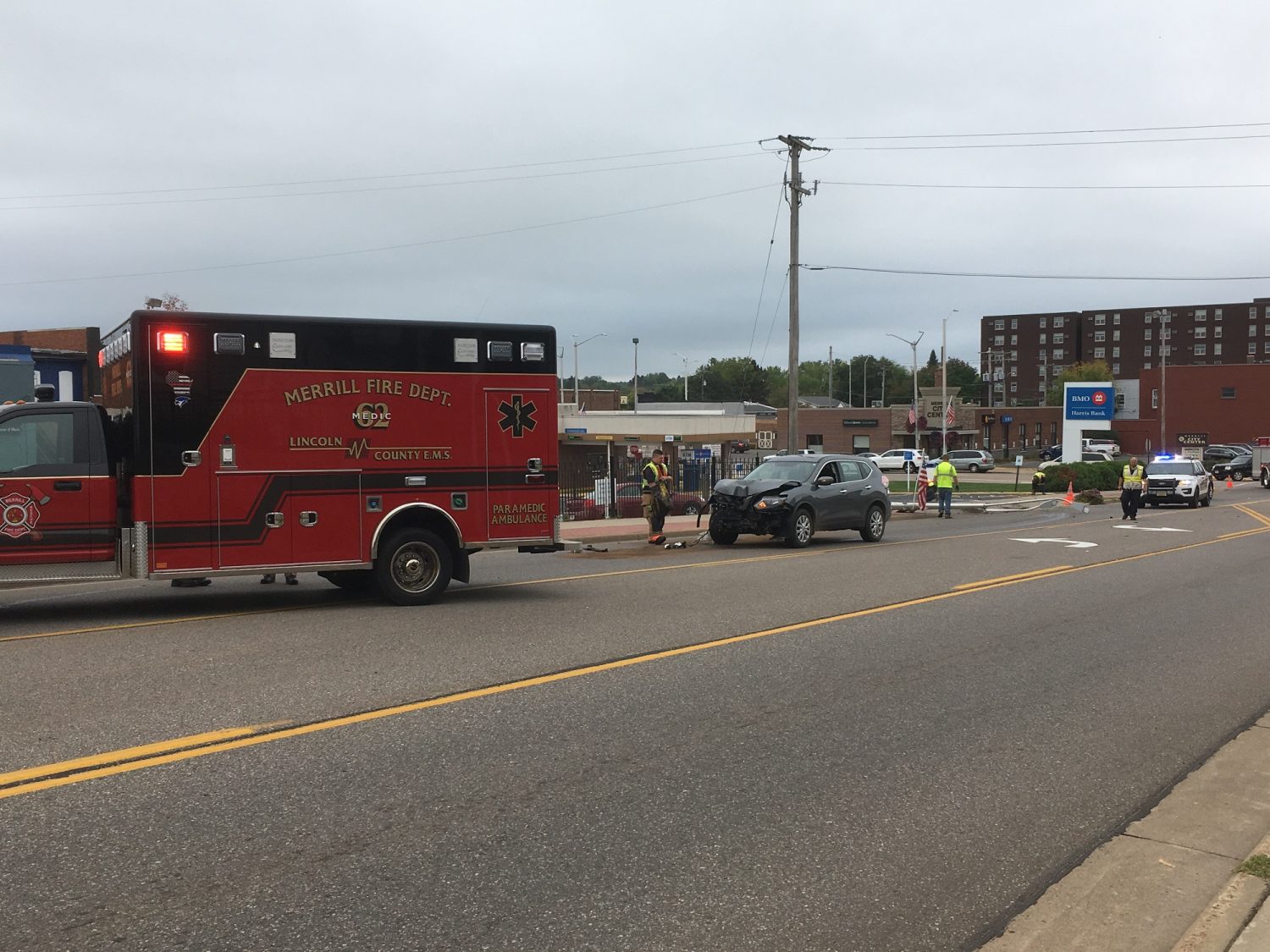 Merrill fire and police on scene of car vs pole crash