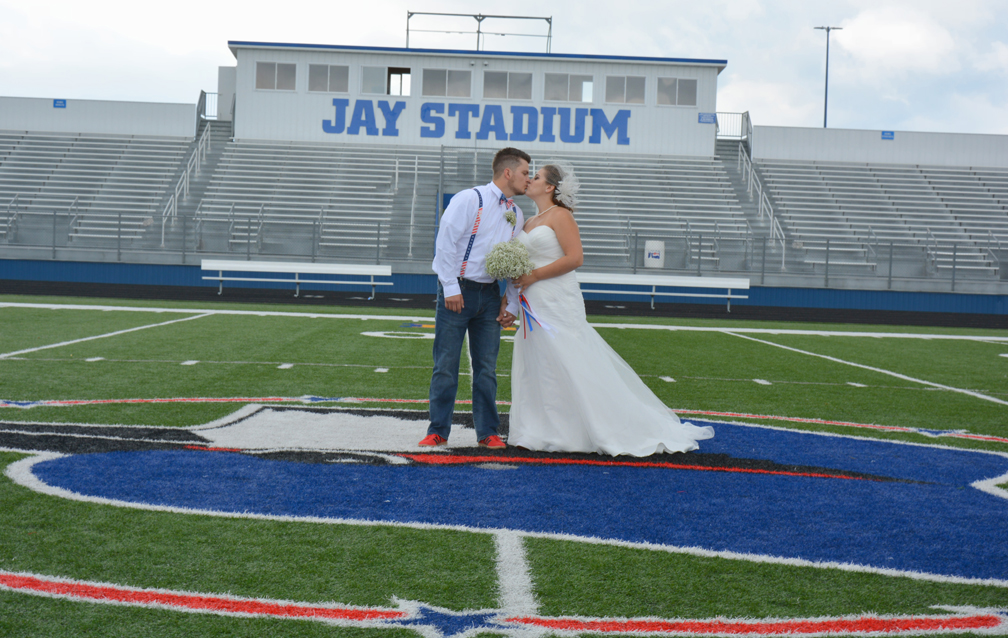 High school sweethearts tie the knot at Jay Stadium