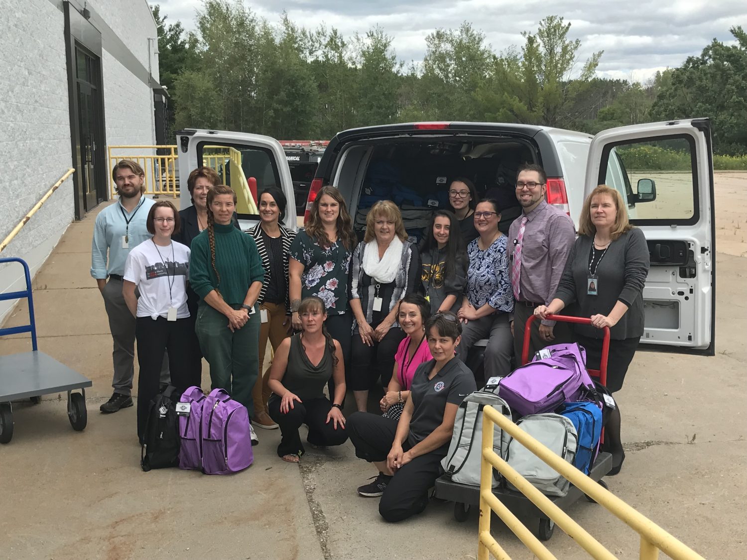 Church Mutual employees stuff backpacks for Operation Homefront