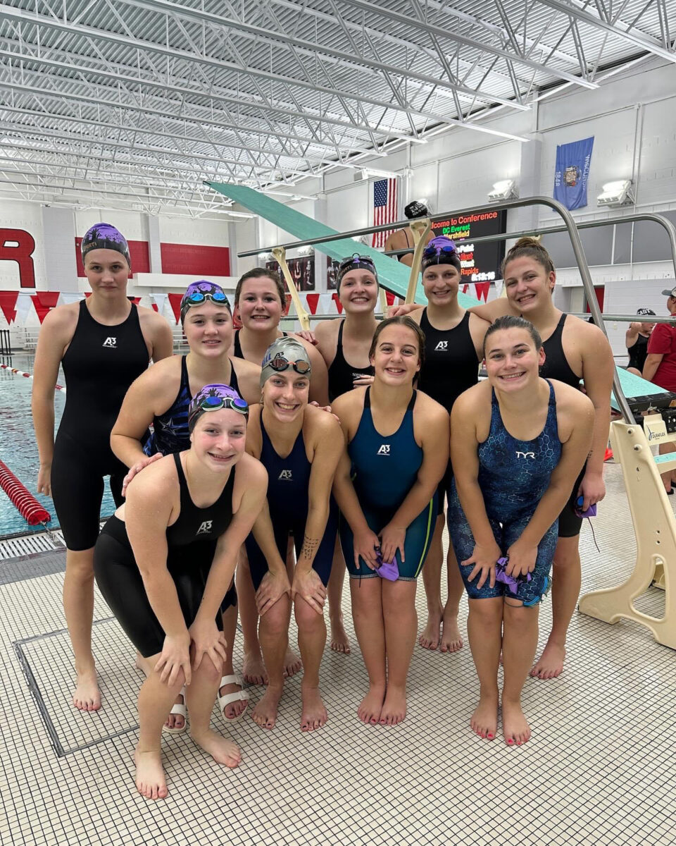 Bluejay Varsity Girls Swim Team at Conference: Miles takes 1st in 100 Yard Freestyle
